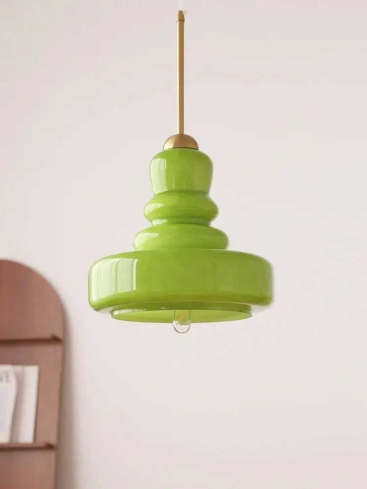 A vibrant lime green glass colorful gourd pendant light with tiered design and brass hardware for kitchen dining room