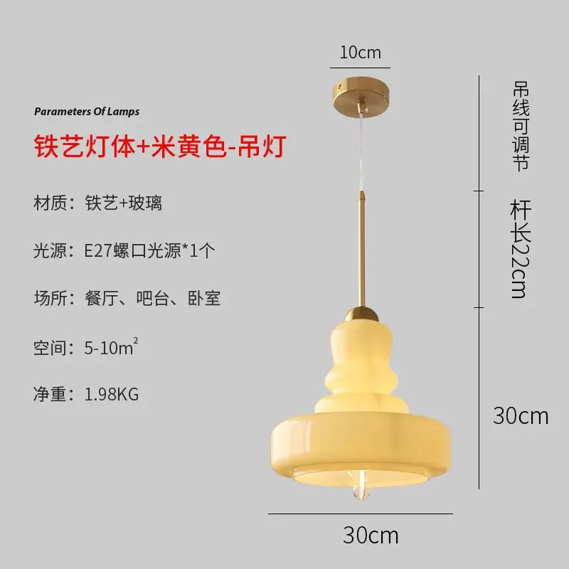 A warm creamy yellow glass pendant light with brass iron frame and adjustable chain for kitchen dining room use
