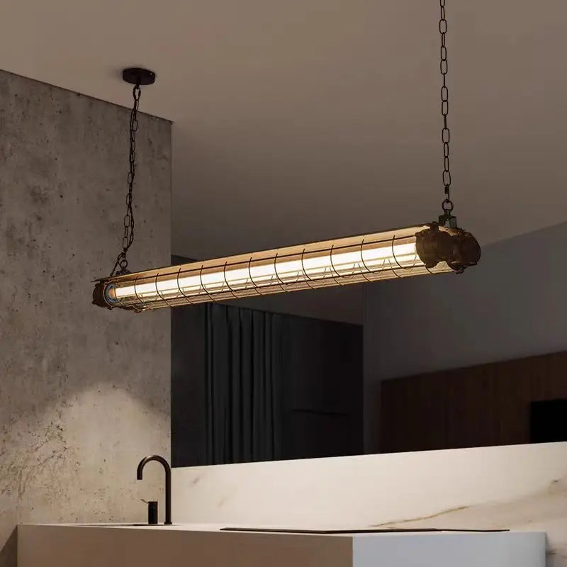 Linear chandelier glass pendant lamp featuring an industrial-style cylindrical glass tube in a metal cage with dark chains