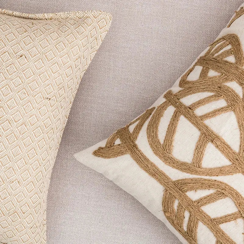 Cream-colored cushion cover with woven geometric pattern and rustic brown rope linen embroidery leaves design