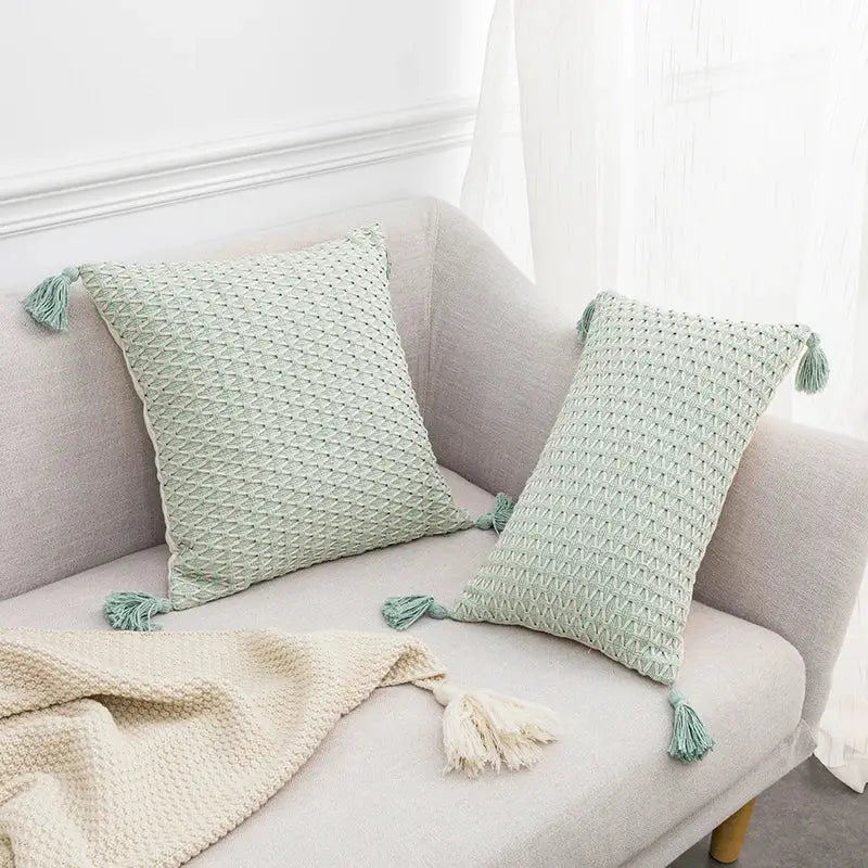Two mint green textured throw pillows with tassels featuring decorbites linen embroidery leaves cushion cover design