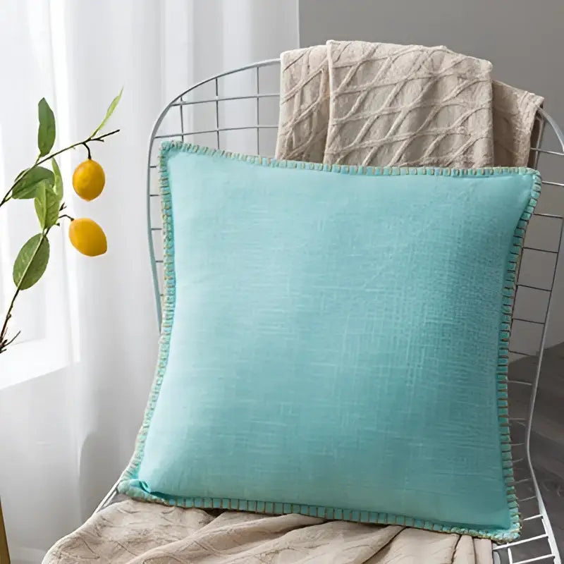 A soft mint green linen fringe cushion cover with textured fabric and neatly stitched edges for neutral decorbites decor