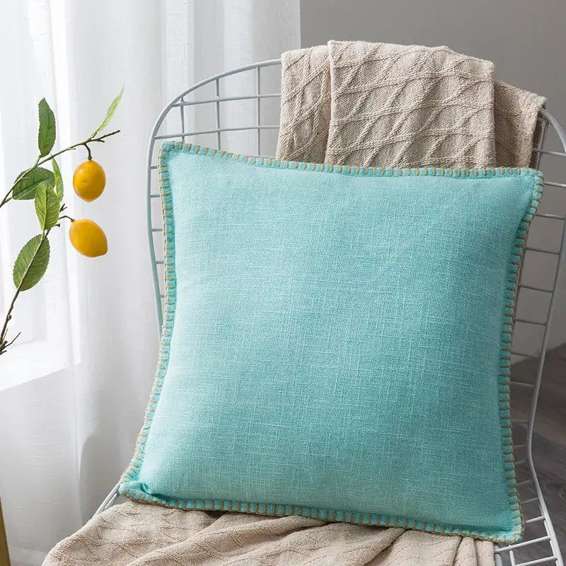 A soft mint green linen fringe cushion cover with textured, slightly frayed edge for neutral tones living room decor
