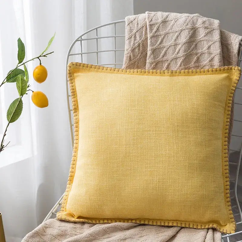 Square mustard-yellow linen fringe cushion cover with textured weave and stitched edges for neutral tones decorbites decor