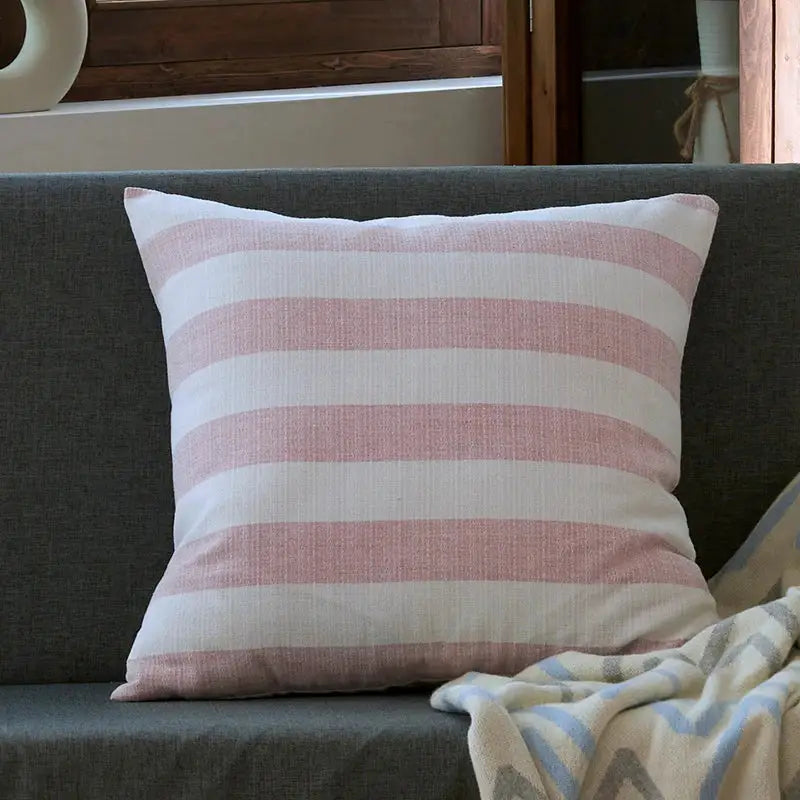 A soft blush pink and off-white linen stripe cushion cover from decorbites for living room decor