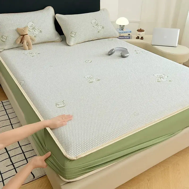 Light green textured cooling mat with subtle bear jacquard embroidery and soft beige border for bedroom use