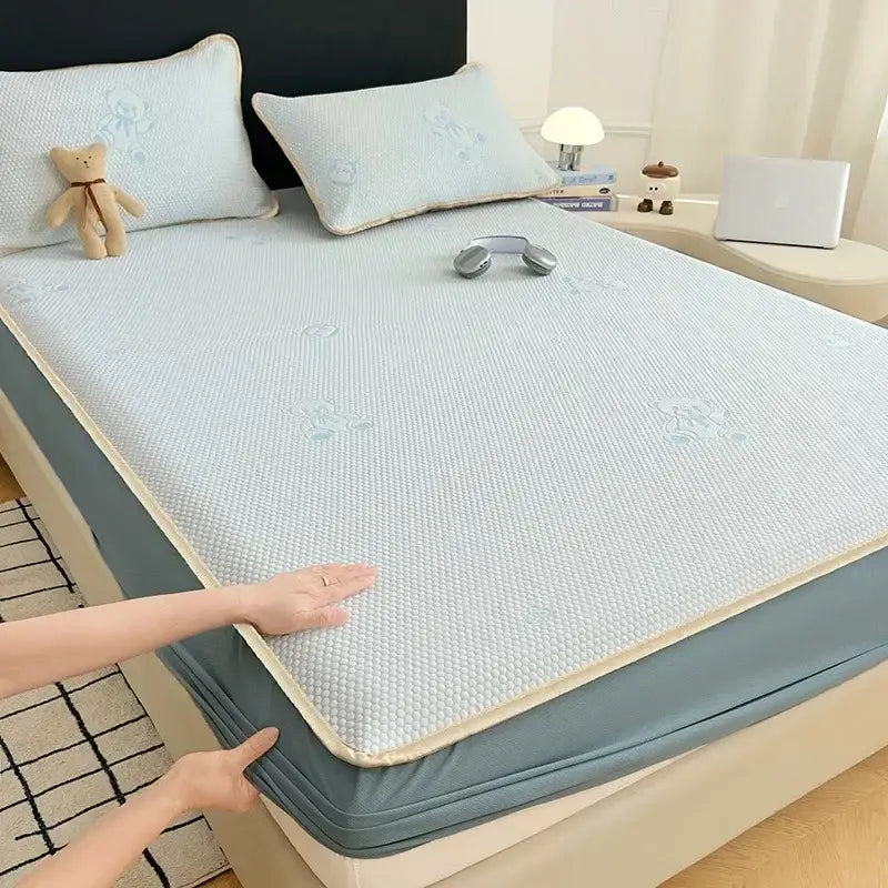Light blue textured cooling mat with bear jacquard pattern and beige border for bedroom mattress pad use