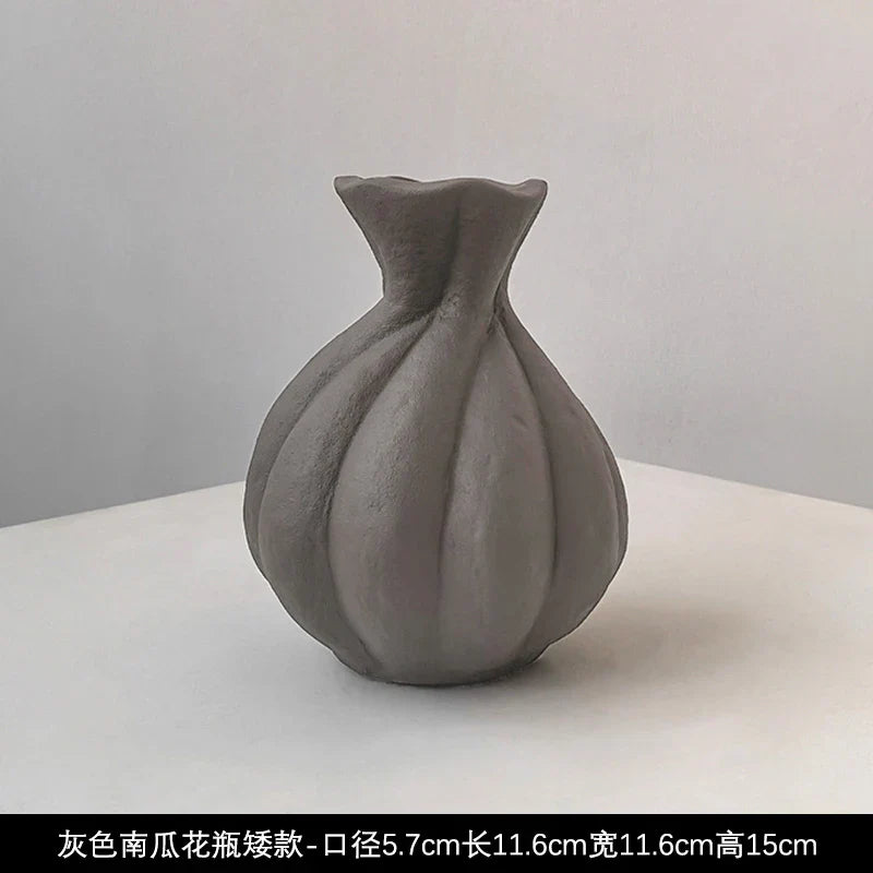 A matte gray Livetai wabi-sabi handmade ceramic vase with a bulbous segmented body and flared neck for modern boho decor