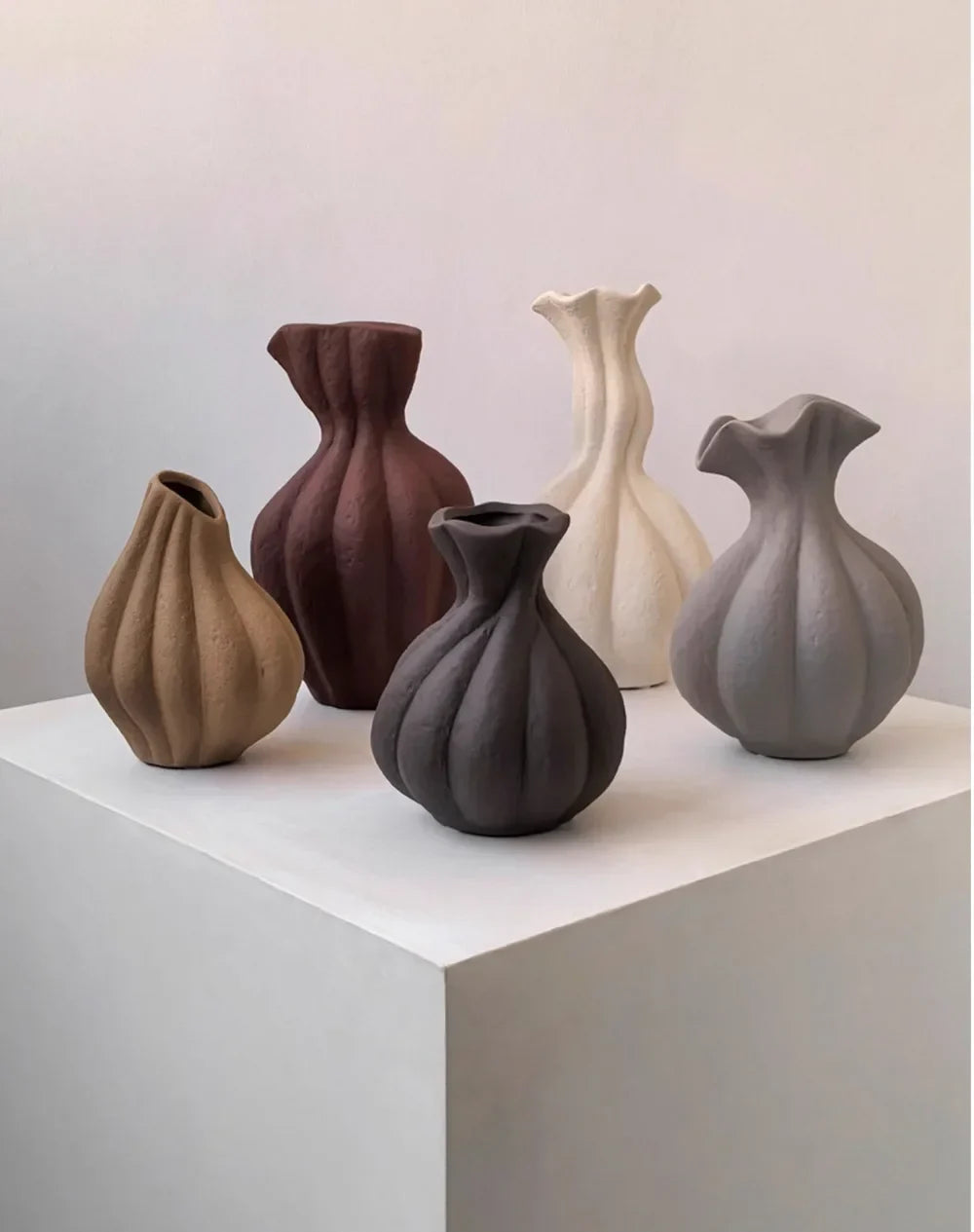 A collection of five Livetai wabi-sabi handmade ceramic vases in earthy tones with organic shapes and textured surfaces