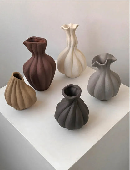 A collection of five livetai wabi-sabi handmade ceramic vases in earthy tones with ribbed organic sculptural shapes for modern boho decor