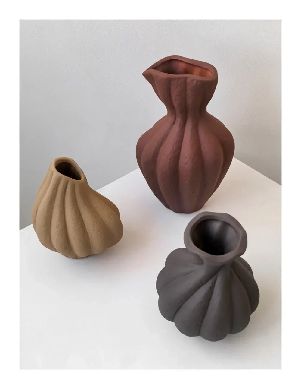 Three Livetai Wabi-Sabi handmade ceramic vases in tan terracotta and charcoal gray with ribbed organic shapes for modern boho decor
