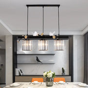 Decorbites black island pendant light with clear crystal cylinder shades and decorative white bird accents
