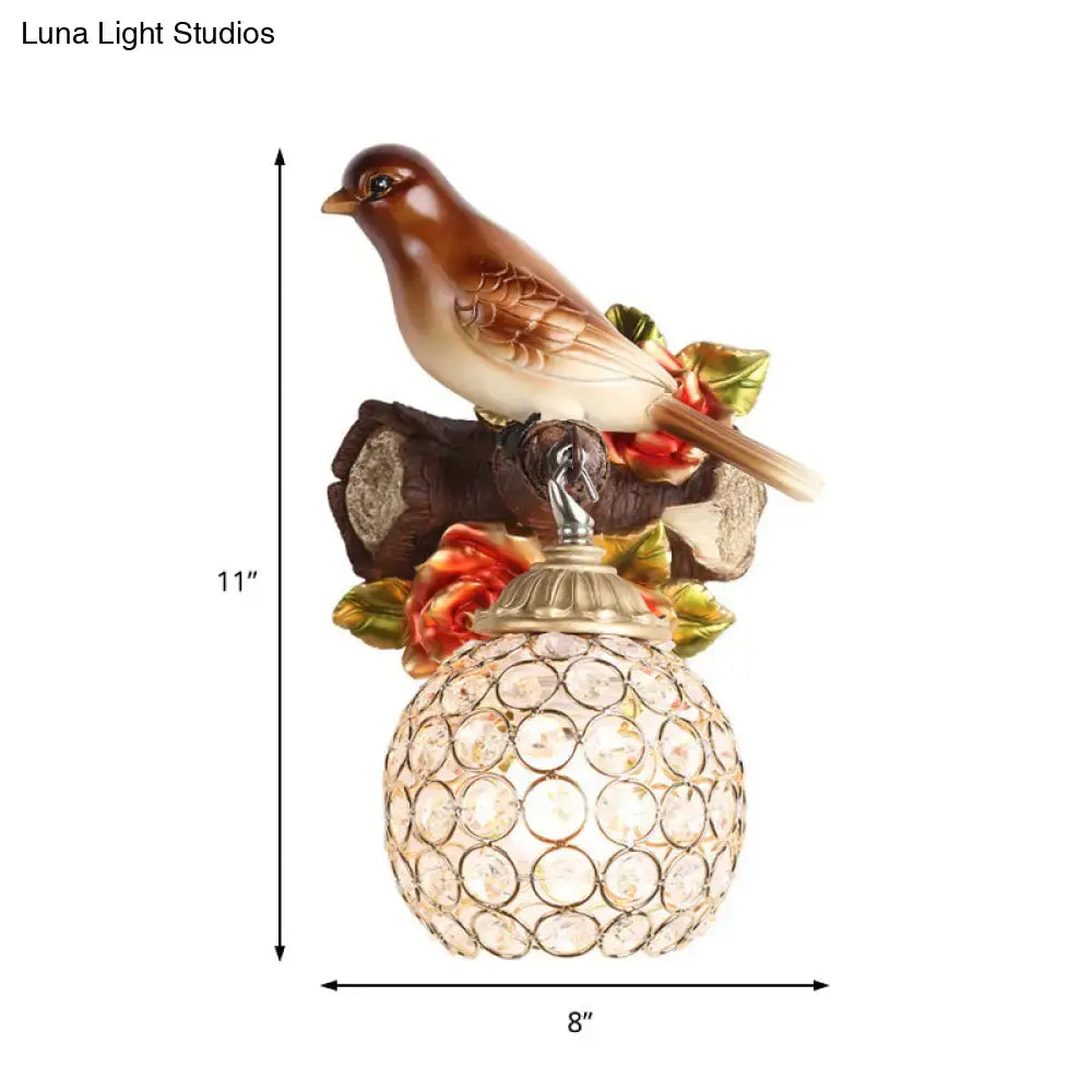Lodge brown and cream bird wall sconce with red roses and crystal global shade featuring a metallic base