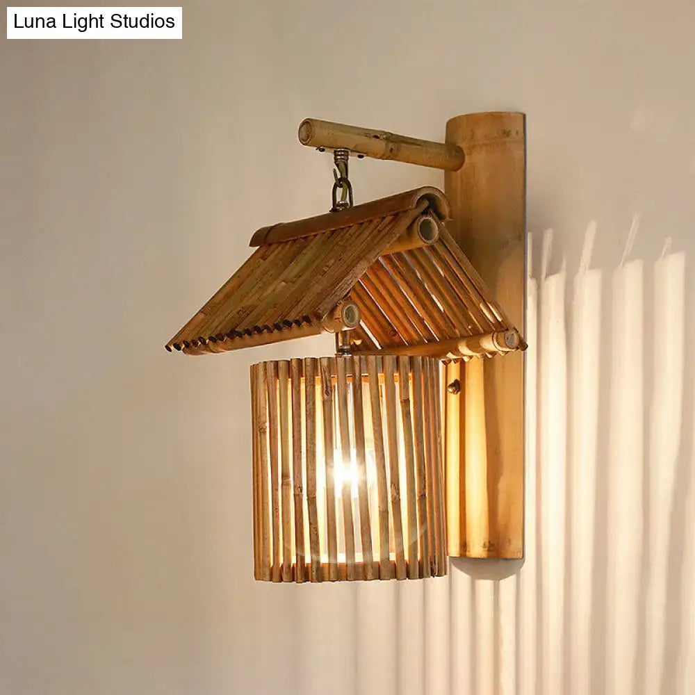 A warm-toned bamboo lodge style wall light with traditional roof design and vertical slats compatible with e26 e27 bulbs