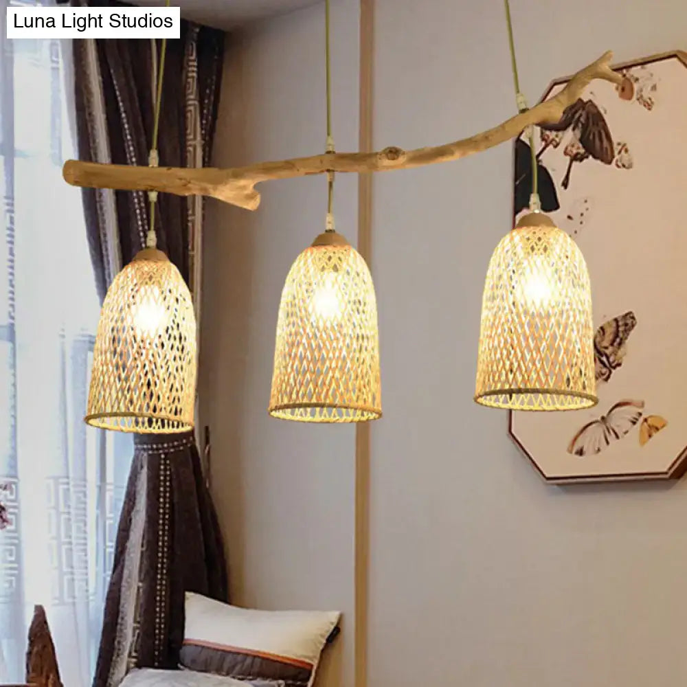 Lodge style wood pendant light featuring a natural wood branch and three woven rattan shades for dining room use