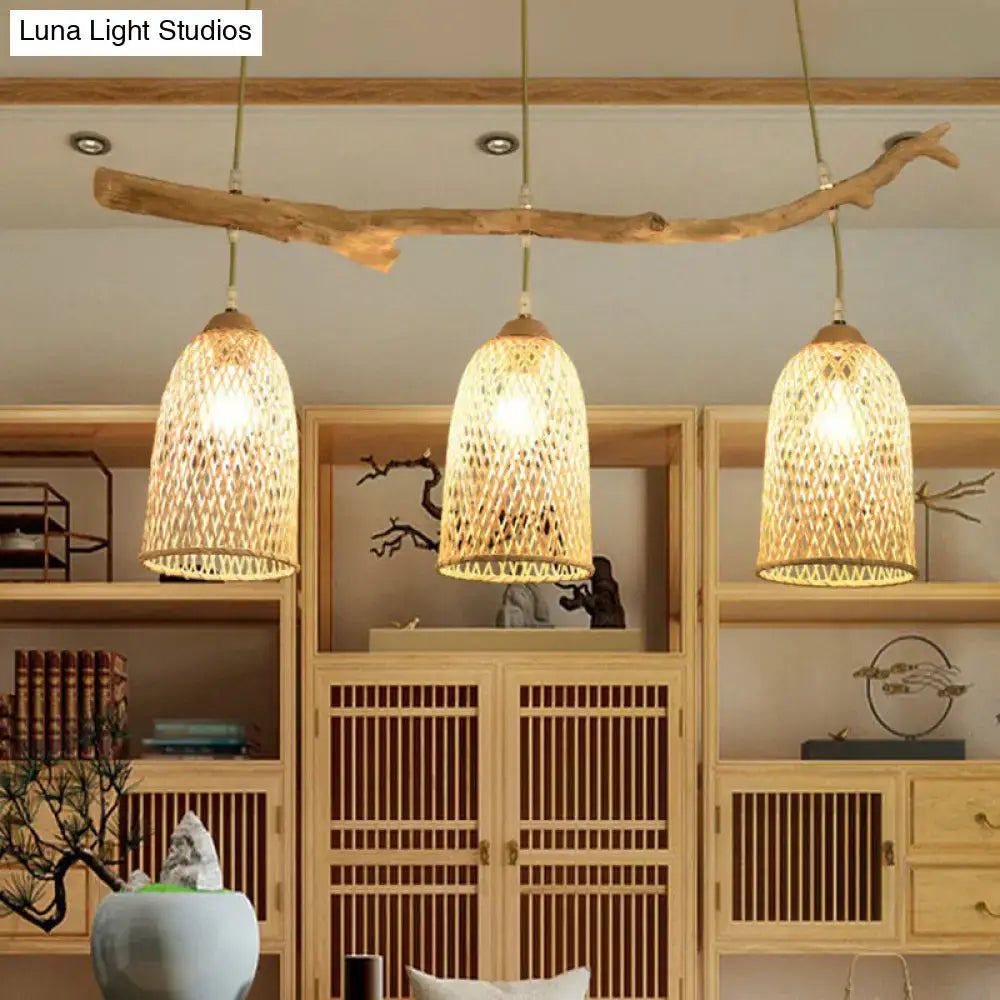Lodge style wood pendant light with natural wood branch and three woven rattan shades for dining room lighting