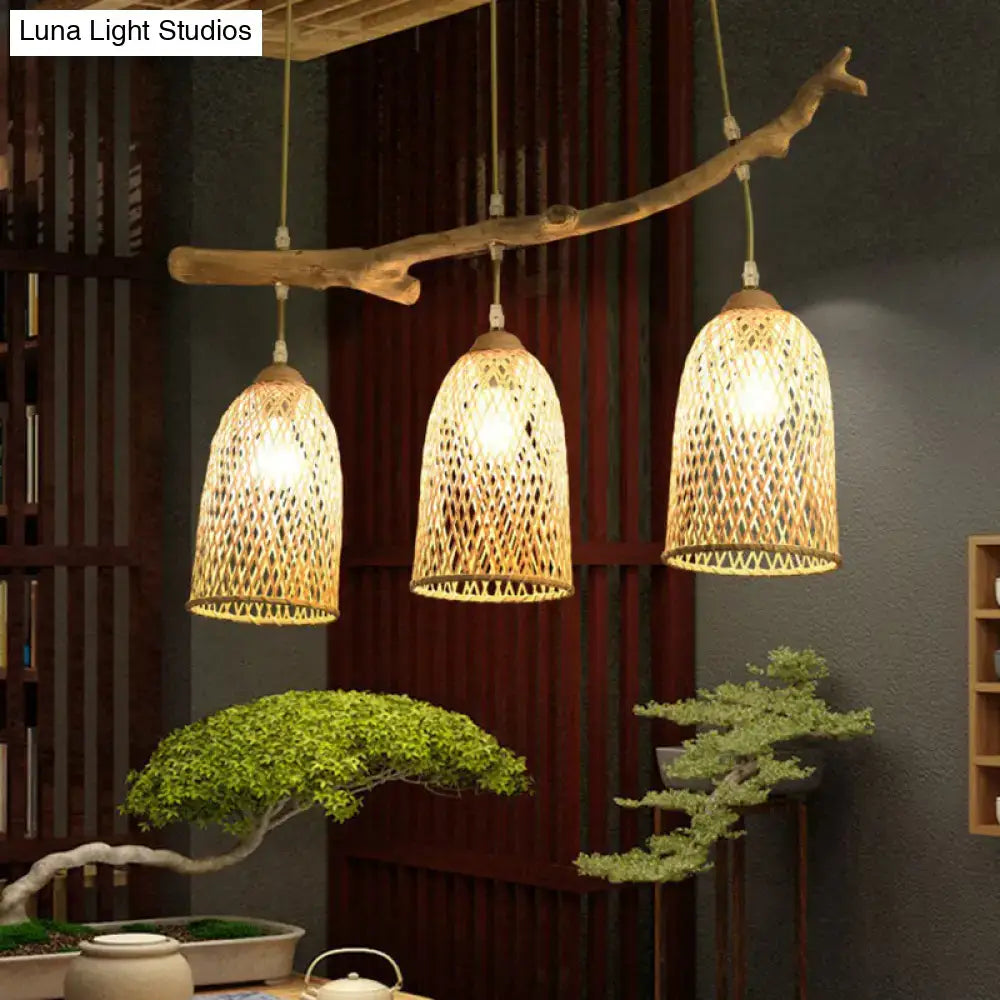 Lodge style wood pendant light with natural wood branch and three woven rattan shades for dining room use