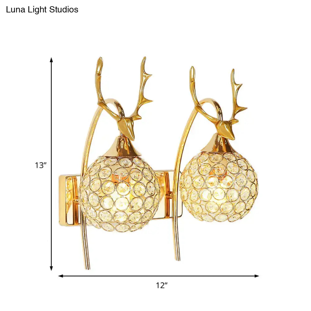 Gold-toned deer wall sconce with crystal dome shade and spherical shades for bedroom wall light fixture