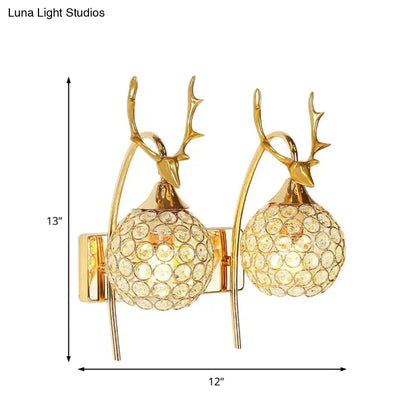 Gold-toned deer wall sconce with crystal dome shade and spherical shades for bedroom wall light fixture