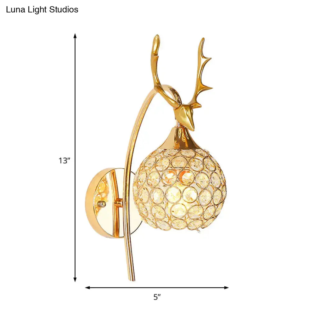 Gold-toned deer head wall sconce with crystal dome shade and white chrome finish ideal as a bedroom wall light
