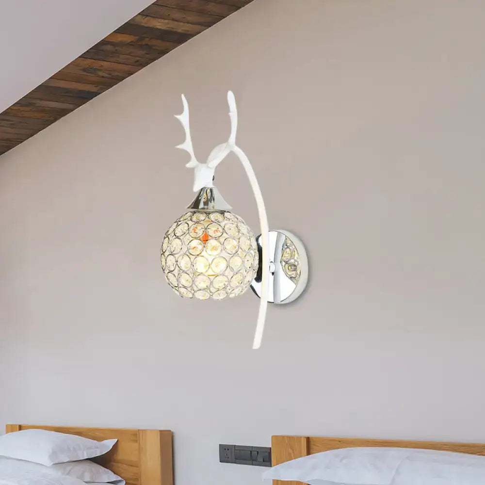 White deer antler-themed wall sconce with crystal dome shade and chrome wall light for bedroom use