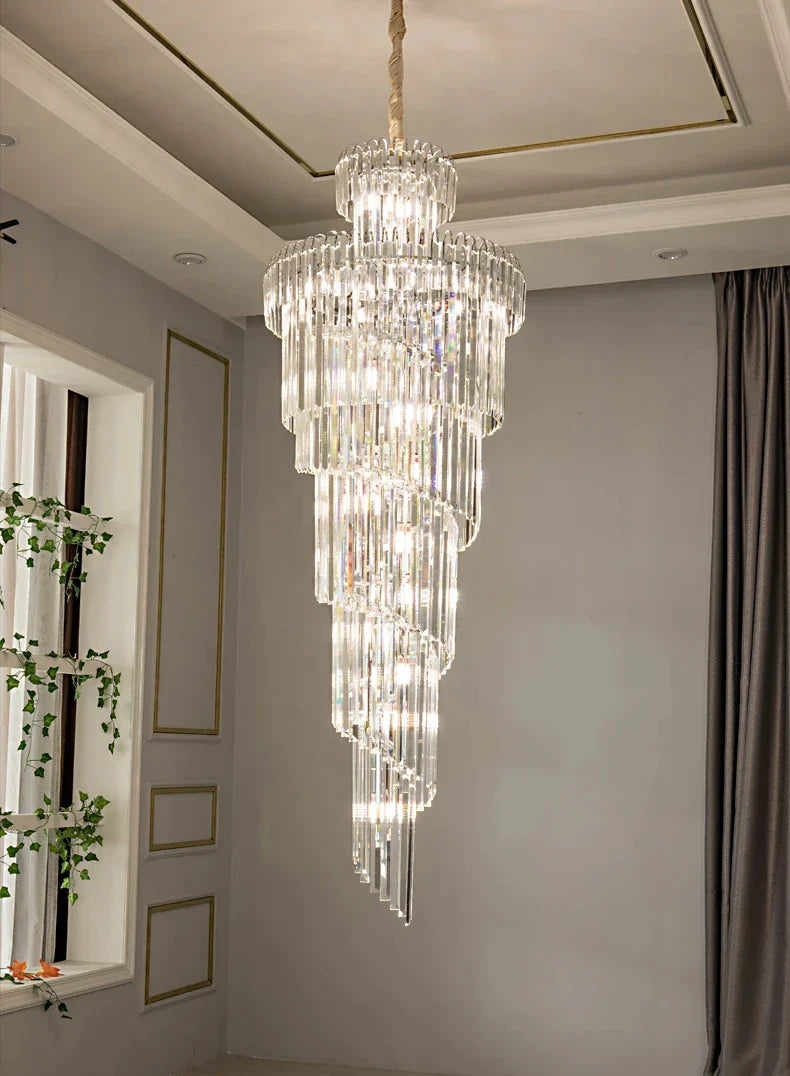 A multi-tiered crystal staircase gold chandelier with cascading glass rods and a gold chain for hotel hall decor