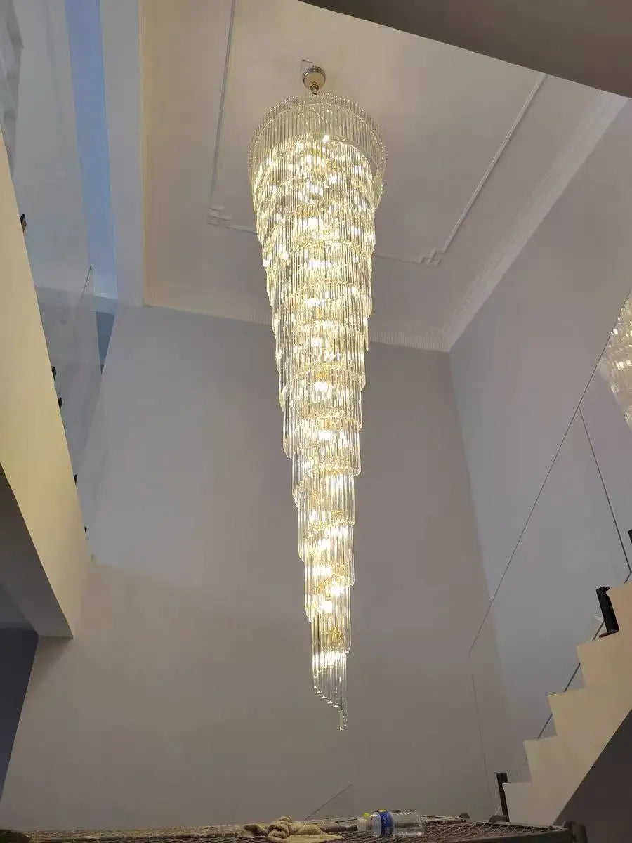 A long crystal staircase gold chandelier with tiered illuminated glass rods for hotel hall and luxury living room decor