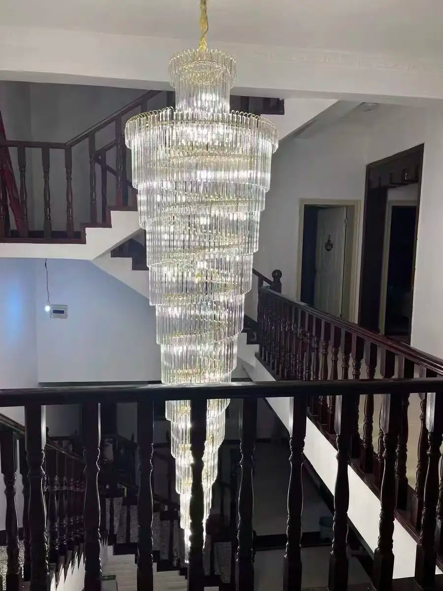 A long crystal staircase gold chandelier with cascading glass rods for luxury hotel hall and villa decor