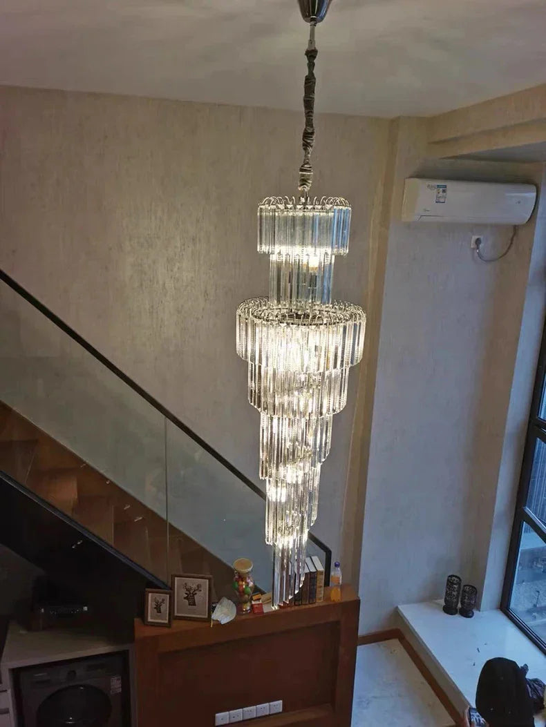 Multi-tiered long crystal staircase gold chandelier with cascading glass rods and dark metal suspension for hotel hall decor