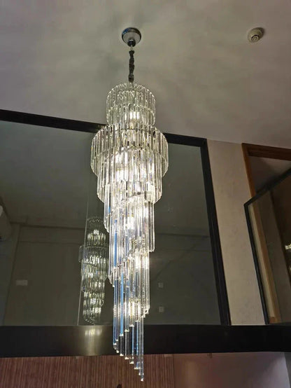 A long crystal staircase gold chandelier with cascading glass rods and metallic mount for hotel hall luxury decor