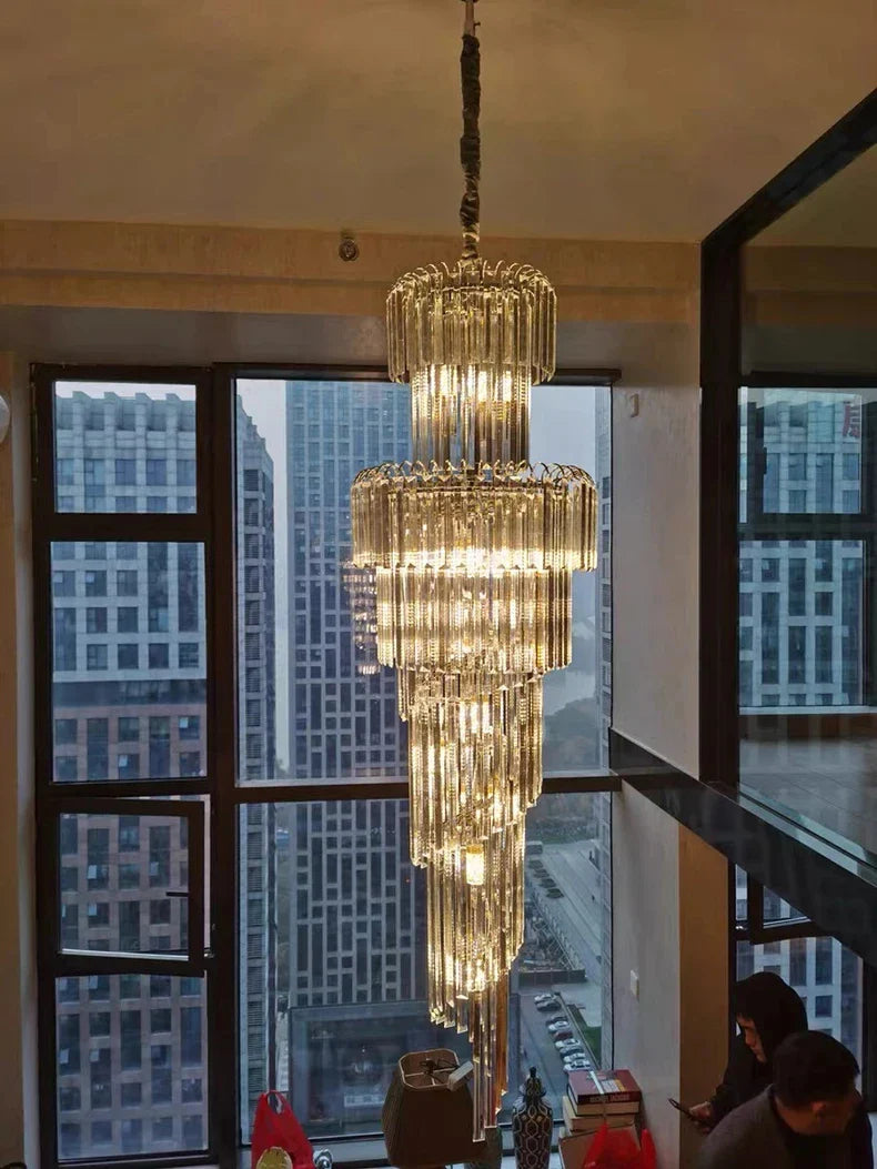A multi-tiered long crystal staircase gold chandelier with golden crystal rods for hotel hall and luxury living room decor