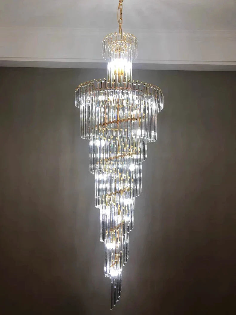 A multi-tiered long crystal staircase gold chandelier with cascading glass rods for hotel hall and luxury home decor