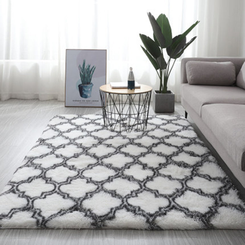 White and gray geometric patterned rug with a soft, plush texture.