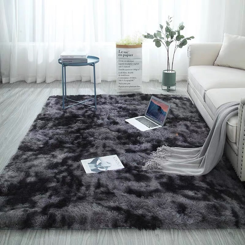 Charcoal gray plush rug with black speckles, soft and luxurious feel.