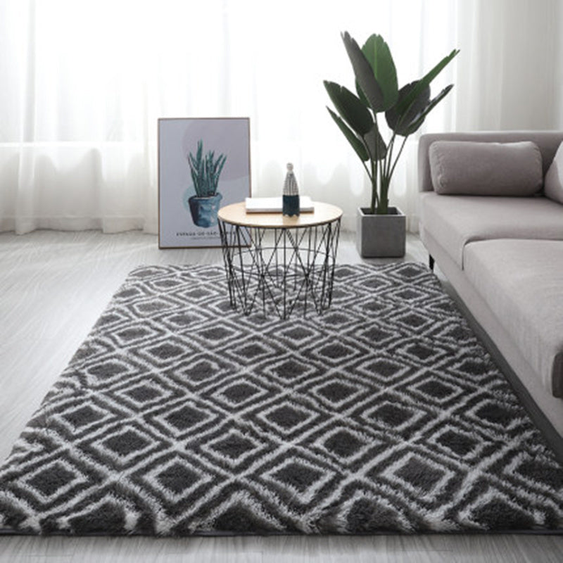 Charcoal gray and white geometric patterned rug with a plush texture.