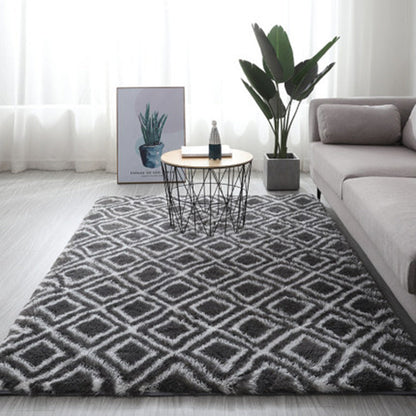 Charcoal gray and white geometric patterned rug with a plush texture.