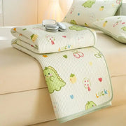 A cream-colored quilted cotton mattress mat featuring a lucky dinosaur decorbites cartoon pattern for bedroom bedding