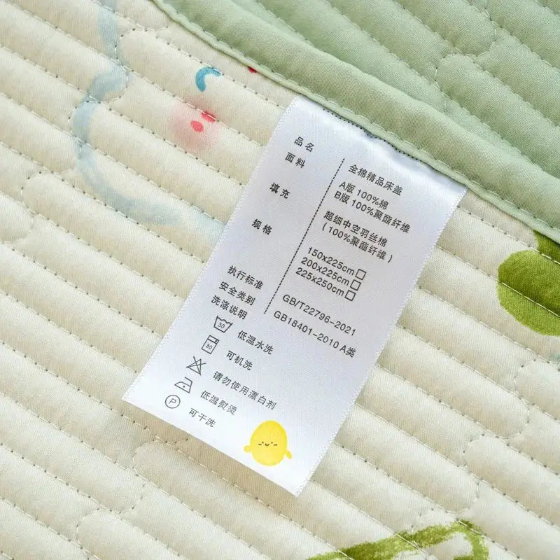 White fabric care label with black chinese text and yellow chick on the back of lucky dinosaur cartoon pattern cotton mattress mat
