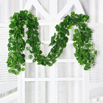 A lush green silk creeper plant with detailed leaves and vines draped over a white lattice for decorbites green silk decor