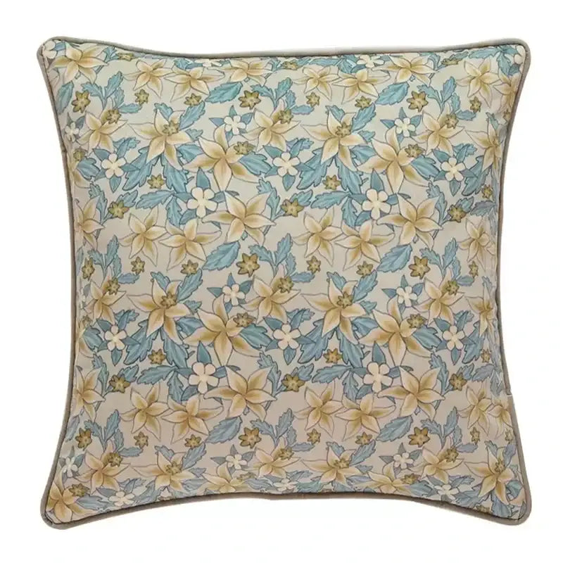 Luxe blue and gold camellia floral velvet cushion cover with delicate yellow and blue floral pattern on off-white background