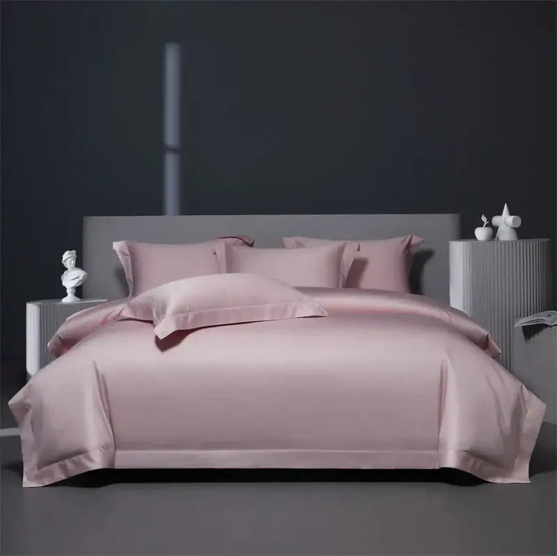 A soft blush pink satin bedding set with matching pillows contrasts with luxe burgundy red egyptian cotton style