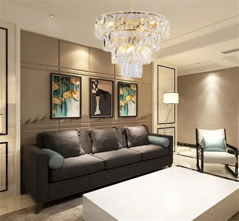 A luxe gold steel crystal pendant light dining room chandelier with multi-tiered cascading clear crystals and gold accents