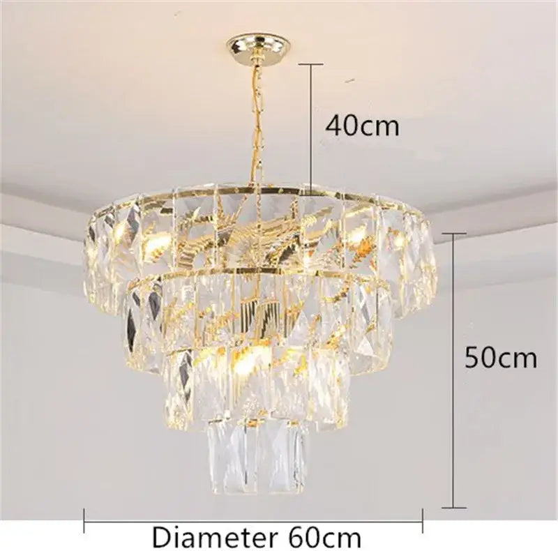 A luxe gold steel crystal pendant light chandelier with multi-tiered faceted glass and gold-toned metal accents