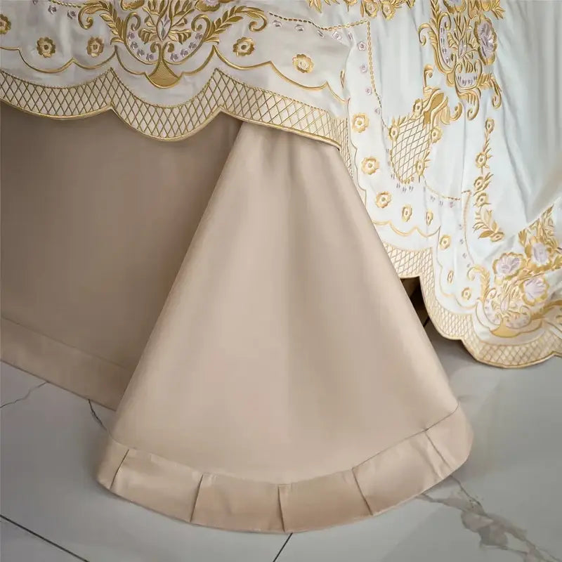 Beige satin bed skirt with ornate gold embroidery and scalloped edge from luxe ivory and gold embroidery bedding set decorbites 1000tc egyptian