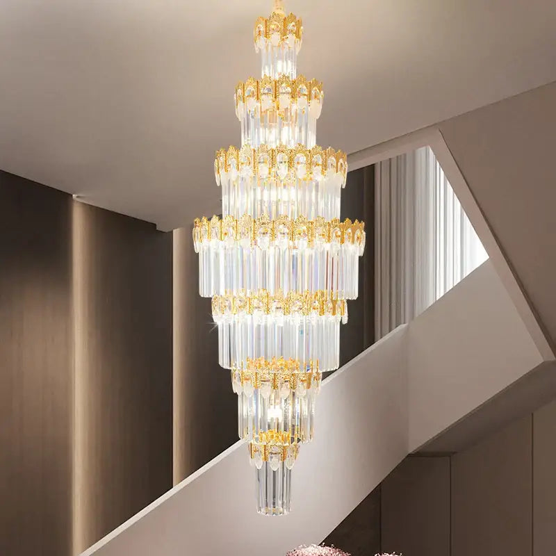 Luxurious gold and clear decorbites crystal staircase chandelier with multi-tiered crystal rods and ornate frames