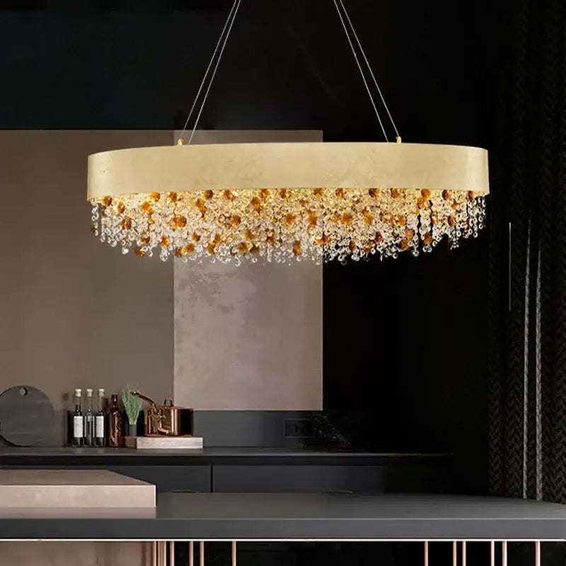 Luxurious gold-toned decorbites circular crystal chandelier with cascading amber and clear crystal droplets pendant light
