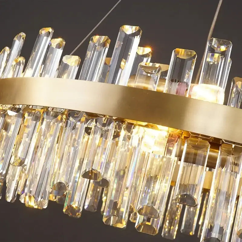 Elegant gold crystal led chandelier with cascading clear prisms designed for living and dining room lighting