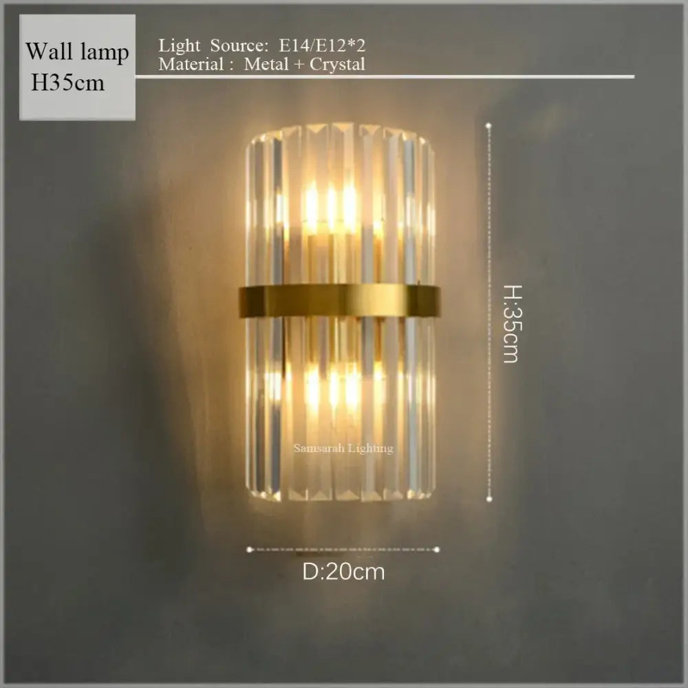 Gold-toned crystal led chandelier wall lamp with vertical crystal rods and central metallic band for elegant interiors