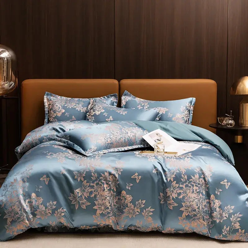 Luxurious gold and teal jacquard satin bedding set featuring a blue satin duvet with floral and butterfly patterns