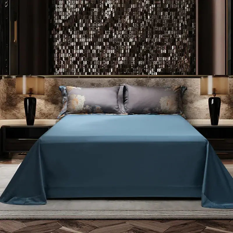 A sleek solid blue satin bedspread with a glossy finish complements a luxurious 1500tc egyptian cotton jacquard bedding set